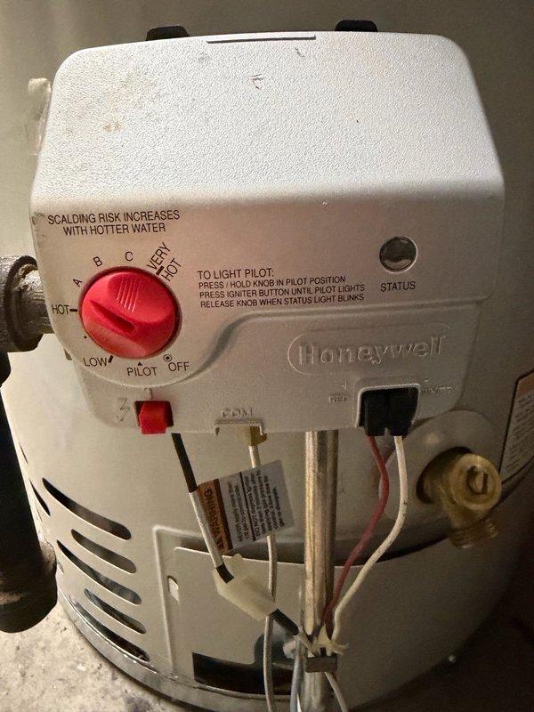 Responded to service call to inspect water heater gas valve. Upon arrival, accessed unit in basement utility area and performed visual inspection of Honeywell gas control valve assembly. Documented existing gas valve with detailed photographs showing model specifications, temperature settings, pilot light controls, and connection points to ensure accurate replacement part ordering. Transmitted images to parts department for proper gas valve identification and procurement.