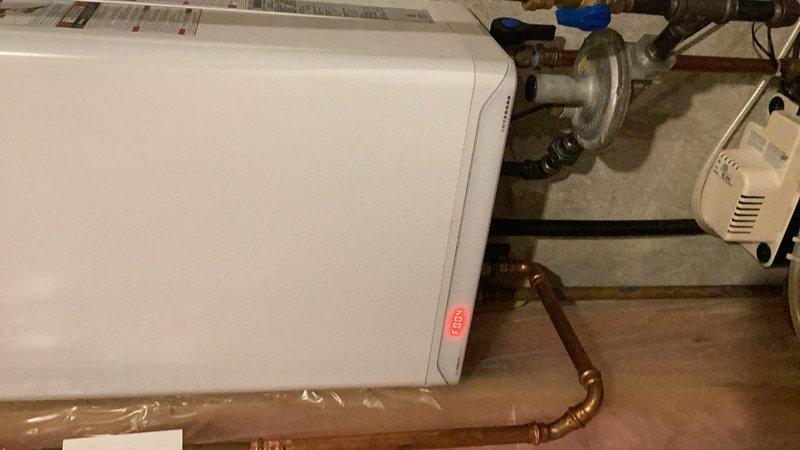 Responded to no hot water complaint affecting entire home. IBC tankless water heater model SFT199 displayed error code F004 indicating ignition failure. Performed system reset which successfully restored unit operation. Cleaned condensate trap and drainage system to ensure proper function. Inspected electrical connections and control board, noting potential electrical board degradation as possible cause of error code. Unit operational at time of departure with hot water restored throughout home. Advised monitoring for recurring error codes that may indicate need for control board replacement.