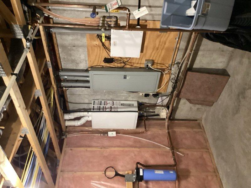 Responded to no hot water complaint affecting entire home. IBC tankless water heater model SFT199 displayed error code F004 indicating ignition failure. Performed system reset which successfully restored unit operation. Cleaned condensate trap and drainage system to ensure proper function. Inspected electrical connections and control board, noting potential electrical board degradation as possible cause of error code. Unit operational at time of departure with hot water restored throughout home. Advised monitoring for recurring error codes that may indicate need for control board replacement.