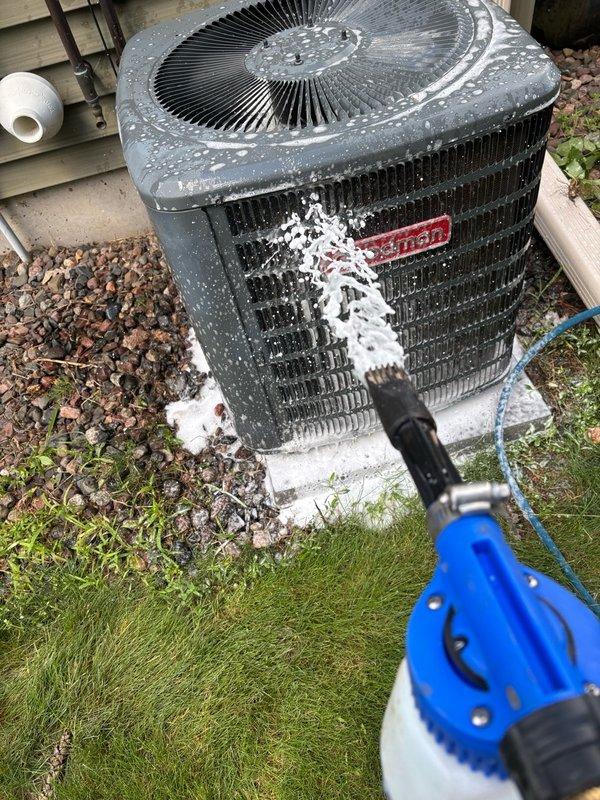Performed comprehensive air conditioning maintenance on a 2018 Goodman condenser unit. Addressed cabinet integrity issues by installing replacement screws to secure loose panels and stabilize the frame. Tested the dual run capacitor, confirming proper operation at 44.8/5.0 µF within manufacturer specifications of 45/5 µF. Verified refrigerant charge with an 18°F temperature split indicating adequate system performance. Cleaned condenser coils and inspected all major components. System is currently operating within normal parameters, though cabinet construction quality warrants monitoring during future service visits.