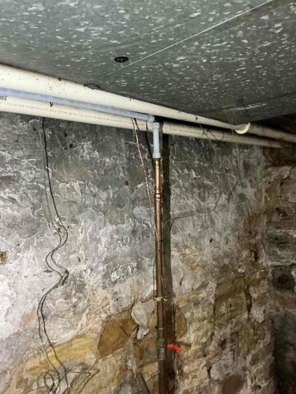 Completed comprehensive repiping of cold water lines throughout the residence per approved estimate. Removed existing deteriorated copper water supply piping and installed new water distribution system to restore proper water delivery to all fixtures. Work performed in basement utility area with routing through foundation spaces as required. All connections pressure tested and verified for proper operation upon completion.