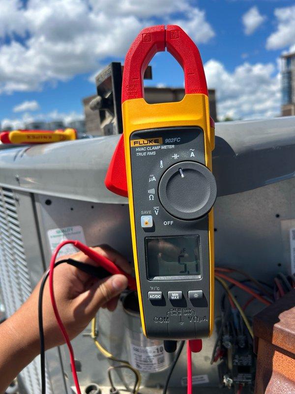 Performed comprehensive AC tune-up on rooftop condensing unit. Conducted thorough maintenance inspection including thermostat operation verification, filter condition assessment (16x16x1), blower assembly examination, outdoor coil inspection, and evaluation of all electrical components including contactor and capacitor. Measured refrigerant performance and temperature split using calibrated instrumentation, with all readings confirming proper system operation within manufacturer specifications. Verified condensate drain functionality and found no mechanical defects or safety concerns. System confirmed operating efficiently with no immediate service needs identified. Recommended continued regular filter replacement and coil maintenance to sustain optimal performance and equipment longevity.