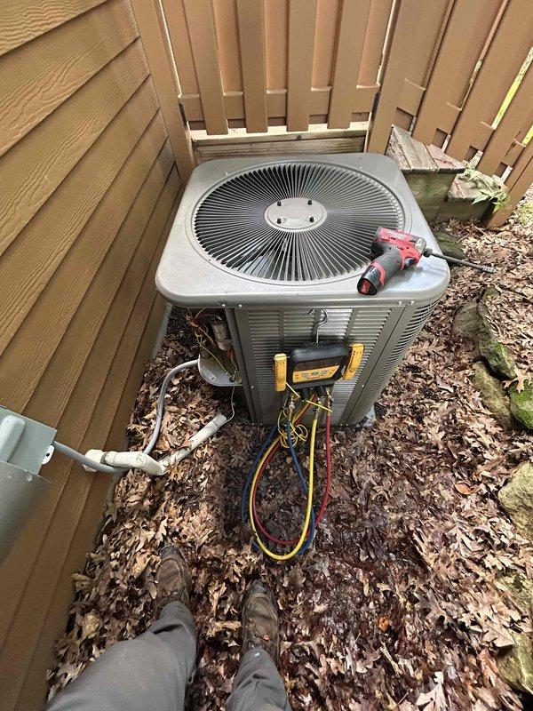 Responded to no cooling complaint on four-year-old system originally installed by our company. Previous contractor had identified low refrigerant charge but declined to service due to warranty concerns. Connected manifold gauges to outdoor condenser unit and confirmed system was operating with insufficient refrigerant charge. Reviewed warranty coverage details and available repair options with homeowner. Recharged AC system to proper operating levels and injected UV leak detection dye into refrigerant circuit to facilitate future leak identification if issue recurs. Verified unit returned to normal cooling operation before departure. System cooling properly upon completion.