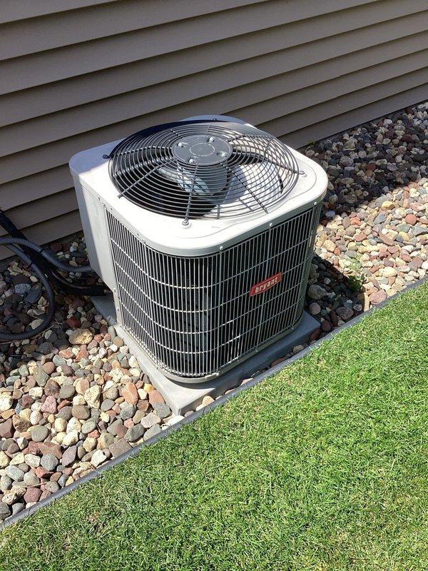 Completed annual AC tune-up and inspection on residential cooling system. Unit operating properly with supply air temperature measuring 53.9°F, electrical connections secure and within specifications, and condenser coils clean with adequate airflow through outdoor unit.