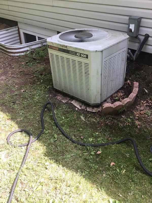 Performed comprehensive tune-up on 1988 Trane XE 900 air conditioning unit with extensive dirt accumulation. Disassembled and thoroughly cleaned condenser coils and cabinet, tested all electrical components including contactor, and measured capacitor readings—fan capacitor within specifications, compressor capacitor reading 32/35 microfarads and recommended for replacement. Confirmed 18-degree temperature split and proper system operation upon completion.