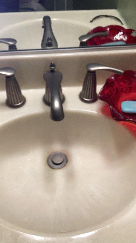 Completed comprehensive plumbing inspection of residential property as part of friends and family program. Evaluated all plumbing fixtures and systems, including bathroom facilities, drainage infrastructure, and under-sink connections. Documented existing conditions with photographic evidence showing traditional three-piece faucet assembly with oil-rubbed bronze finish, white PVC drain-waste-vent piping system with standard residential fittings, and overall plumbing configuration. Identified older Mansfield toilets throughout property and recommended replacement due to age and potential efficiency concerns. All accessible plumbing components inspected and findings communicated for future maintenance planning.