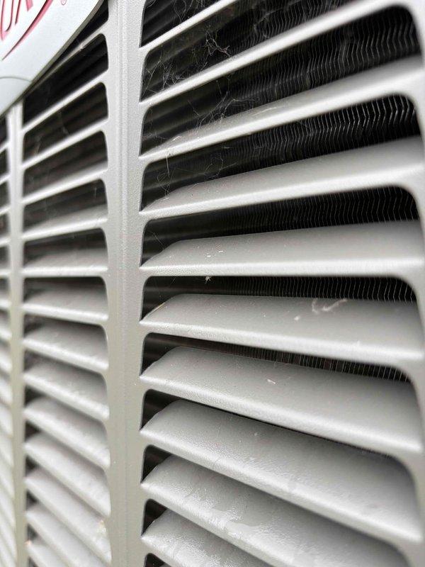 Completed comprehensive AC maintenance on one 3-year-old condenser unit utilizing R-410A refrigerant under 60-degree ambient conditions. Performed full system inspection including filter evaluation, thermostat operation verification, temperature split measurement, condenser and coil examination, motor and capacitor testing, compressor assessment, refrigerant level check, and condensate drain inspection. Accessed interior electrical and control components, inspecting dual circuit boards, wiring connections, and all internal systems. Noted minor debris accumulation on exterior coil fins but system demonstrated normal operational parameters across all tested components with no deficiencies requiring immediate attention.