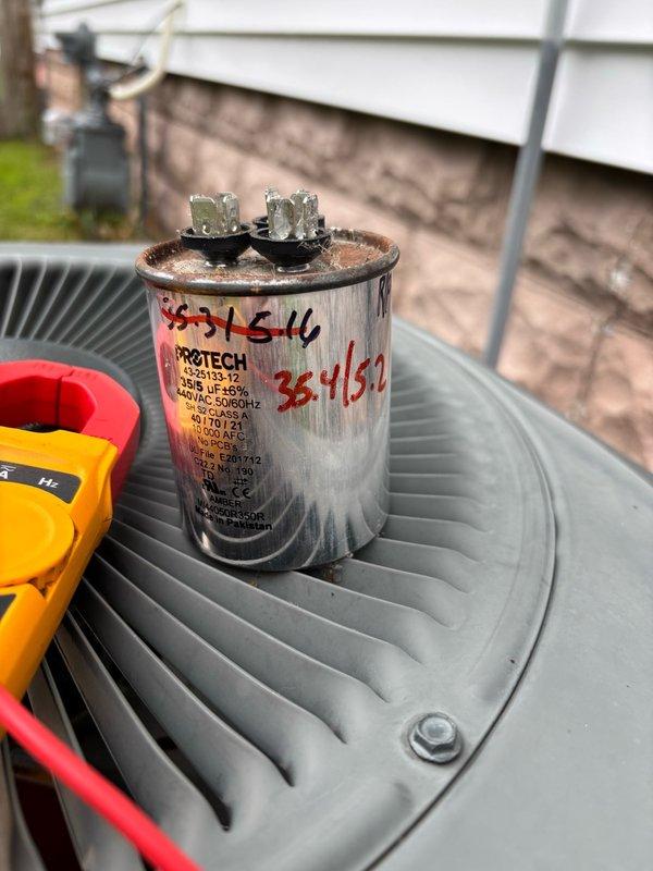 Completed comprehensive preventive maintenance on a 2005 Trane R-22 air conditioning system as part of a recurring maintenance agreement. System is currently operational with an 18°F temperature split across the evaporator coil, though refrigerant charge appears slightly low. Inspected outdoor condenser unit, which showed normal wear consistent with age, and evaluated dual-run capacitor showing corrosion and weathering on terminals. No immediate operational failures detected at this time. Discussed system replacement options with homeowner, highlighting benefits of upgrading from aging R-22 equipment to newer, more energy-efficient technology that would provide quieter operation and improved long-term reliability.