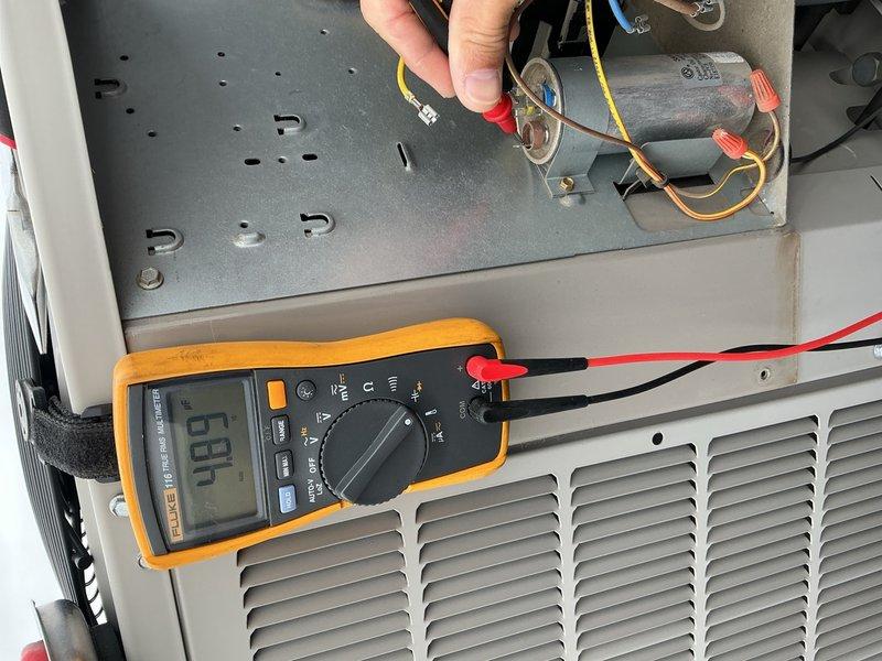 Performed comprehensive AC tune-up on 9-year-old rooftop unit. Accessed rooftop system with key obtained from front desk. Inspected and verified 20x20x1 air filter in good condition, confirmed proper blower speed and clean evaporator coils. Conducted electrical diagnostics on rooftop condenser unit using digital multimeter, testing capacitor functionality, contactor operation, and all electrical connections. Verified refrigerant charge levels within manufacturer specifications. All system components found operating within normal parameters with no deficiencies noted. Unit confirmed ready for continued summer operation.