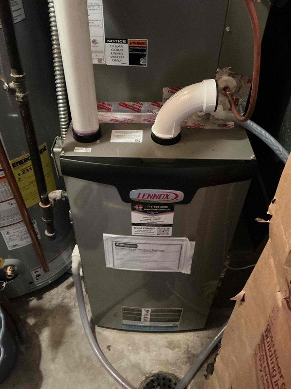 Performed comprehensive AC tune-up on 2-year-old Lennox system. Removed cottonwood debris and thoroughly cleaned outdoor condenser coil to restore optimal airflow and heat transfer efficiency. Inspected all system components including compressor, condenser fan motor, electrical connections, and capacitors—all testing within manufacturer specifications. Verified refrigerant charge levels are correct with no leaks detected. System is fully operational and running efficiently.