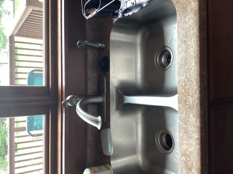 Completed comprehensive plumbing inspection for friends and family service call. Evaluated existing Mansfield builder-grade toilets throughout the residence and assessed current Delta faucet installations in kitchen and bathrooms for potential whole-house upgrade. Referred customer to supplier for fixture selection, with plans to replace all faucets pending customer's final choices. Documented kitchen sink configuration featuring stainless steel double-basin setup with single-handle faucet. Coordinated inspection with scheduled HVAC service for comprehensive property assessment.