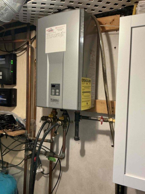 Performed maintenance flush on 18-year-old Rinnai tankless water heater operating on well water with no filtration system. Unit showed remarkable longevity despite challenging water conditions measuring 16 grains per gallon hardness and total dissolved solids exceeding 3000 ppm. Successfully completed descaling flush procedure to remove mineral buildup and restore optimal performance.