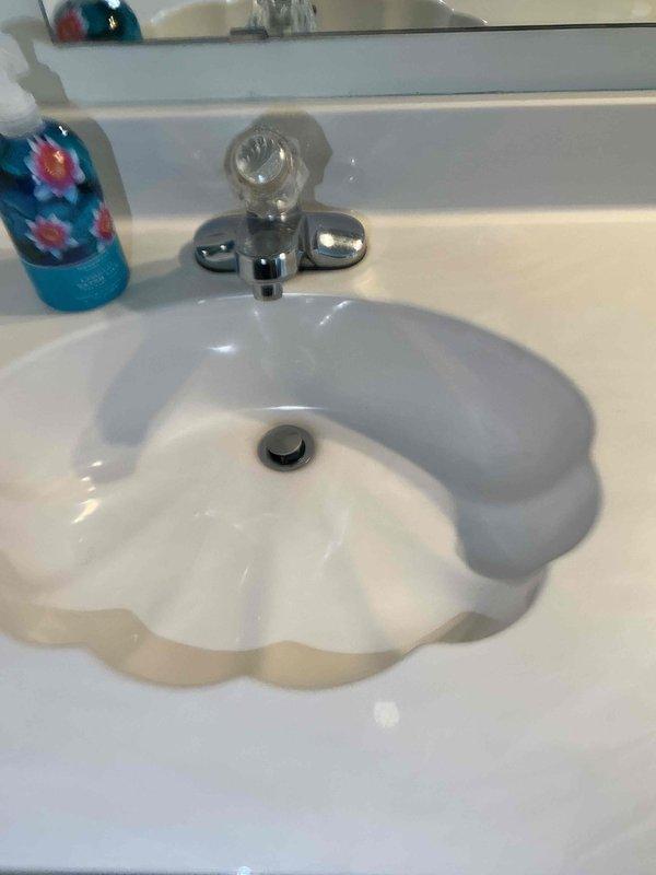 Responded to service call for leaking tanked water heater with water present on mechanical room floor. Upon inspection, identified soft discharge line as source of drip. Tightened discharge line connection to stop leak and verified unit continued to produce hot water properly. Performed complete plumbing system inspection of residence to ensure no additional issues were present.