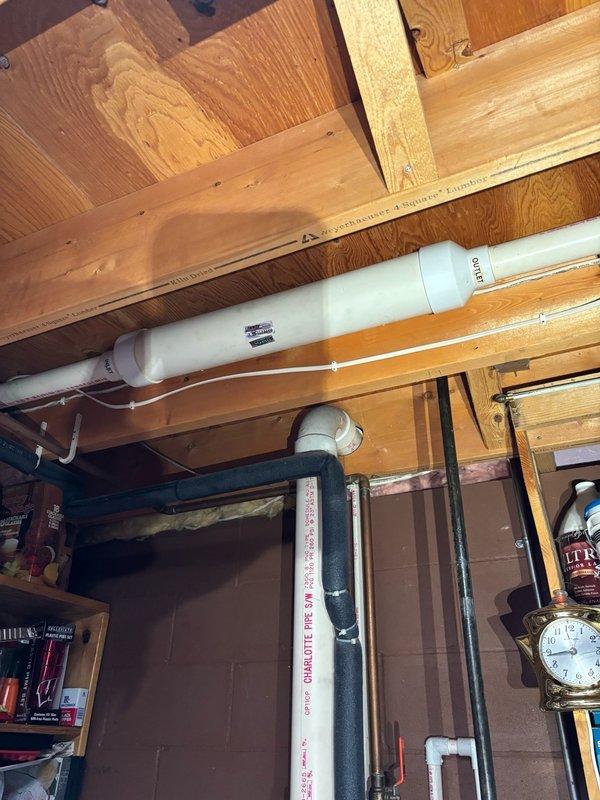 Performed annual A/C maintenance on a 2022 Lennox furnace and condenser system. Removed access panels, cleaned condenser coil, and verified run capacitor is operating within manufacturer specifications. Identified legacy component from previous Lennox Pulse system installation—combustion-air intake muffler remains attached to current PVC intake piping. All equipment operating normally with no functional issues detected. Recommend evaluation and removal of old Pulse muffler/adapter assembly if not required for current furnace venting design, as insufficient PVC materials were available on-site to complete replacement at this time.