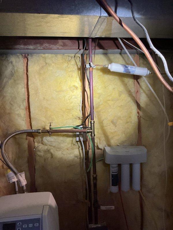 Replaced failed water supply shutoff valves and deteriorated copper piping section serving the ice maker connection. Installed new shutoff valves and copper supply line to ensure proper water delivery and emergency shutoff capability, preventing potential water damage from compromised components. Work completed in unfinished basement utility area with all connections tested and verified operational.
