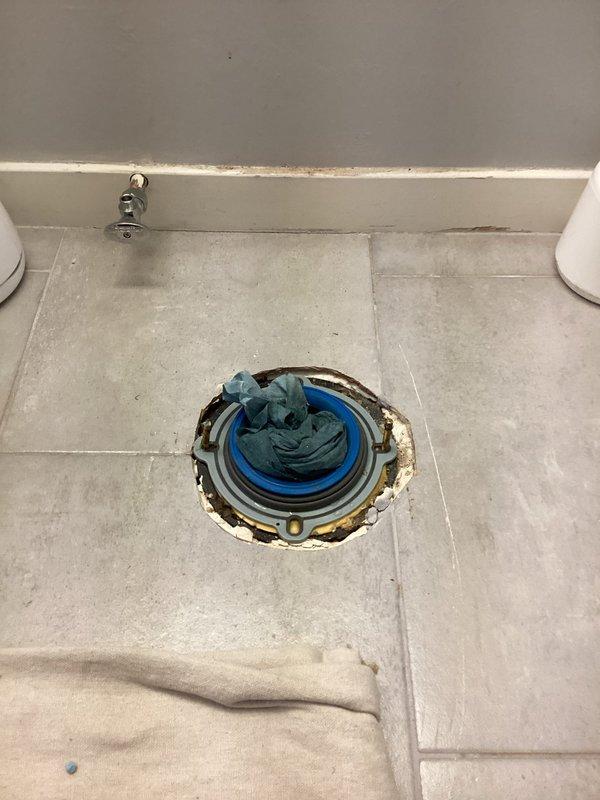 Replaced four standard height toilets throughout the property, including new wax rings, mounting bolts, and complete installations. Addressed corroded toilet flanges showing significant rust and water damage staining on surrounding tile surfaces. Installed shut-off valves and bidet seat as needed. Investigated lack of hot water to master bathroom shower by cutting access opening in master closet wall to expose shower valve assembly; additional parts have been ordered for shower valve repair to be completed on return visit.