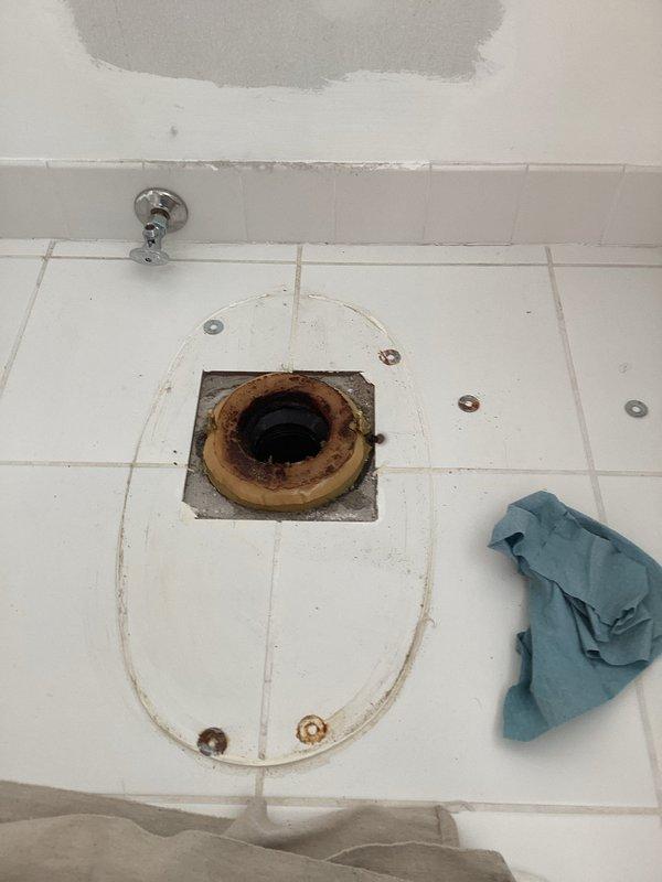 Replaced four standard height toilets throughout the property, including new wax rings, mounting bolts, and complete installations. Addressed corroded toilet flanges showing significant rust and water damage staining on surrounding tile surfaces. Installed shut-off valves and bidet seat as needed. Investigated lack of hot water to master bathroom shower by cutting access opening in master closet wall to expose shower valve assembly; additional parts have been ordered for shower valve repair to be completed on return visit.