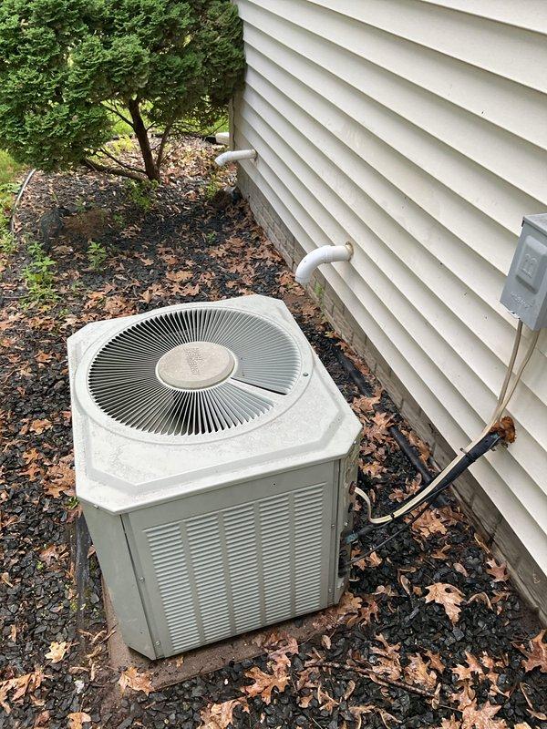 Completed comprehensive cooling system maintenance on residential air conditioning unit. Performed indoor inspection including furnace examination, air filter assessment, and temperature differential measurement confirming optimal 21-degree split across the evaporator coil. Conducted outdoor condenser service including full disassembly, coil cleaning, capacitor testing, and refrigerant pressure verification. Unit operational since 1994 continues to function within acceptable parameters. Noted condenser fan motor exhibiting oil seepage, indicating bearing wear consistent with equipment age; motor remains functional but approaching end of service life. All maintenance tasks completed per preventive maintenance protocol with system operating properly at time of departure.