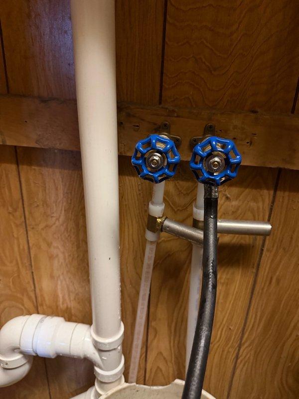 Responded to water leak at washing machine hookups where a recently installed shutoff switch was not fully closing, requiring the hot water supply to be shut off at the source to stop the leak. Upon inspection, determined the washing machine shutoff valve body was defective and leaking. Removed the faulty valve body assembly and installed new hose bibs for the washing machine connections, restoring proper water shutoff functionality and eliminating the leak.