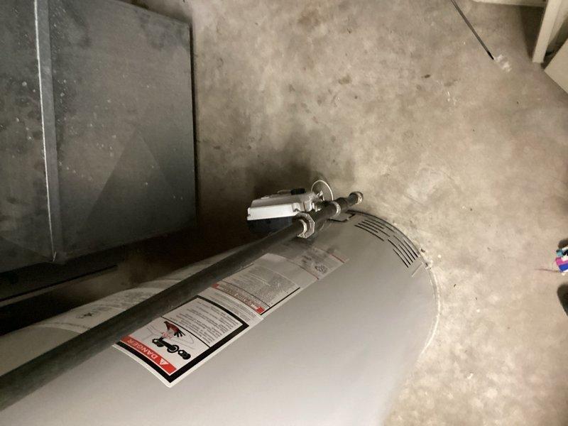 Responded to callback for reported gas odor following water heater gas valve replacement. Upon inspection, identified gas leak at connection point between gas supply valve and pilot assembly. Tightened connection nut to seal leak and verified system integrity before departure.