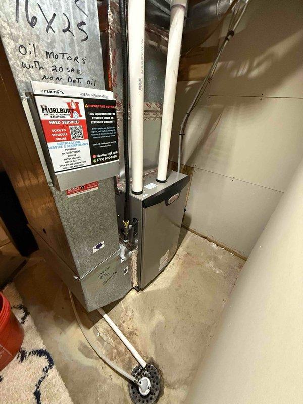 Responded to callback for water leaking under furnace. Investigated and found furnace cabinet and filter area dry, but discovered water dripping down backside of ductwork. Disassembled ductwork and identified all three condensate pan drain plugs were leaking slowly. Sealed all three plugs with Teflon tape and pipe dope, then performed water test to verify leak was resolved. Reassembled ductwork, verified correct airflow settings for air conditioning system, and cleaned heavy cottonwood debris from outdoor condenser coil as courtesy service.