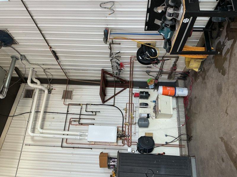 Removed and replaced failed leaking combination boiler with new IBC tankless combi unit in commercial facility. Completed installation of new boiler system with copper piping, brass valves, and necessary fittings. Successfully commissioned domestic hot water side of system and verified operation. Heating zone wiring remains incomplete and requires return visit to finalize electrical connections for space heating functionality.