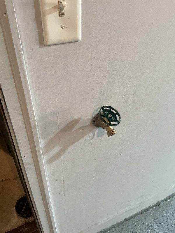 Responded to a leaking garage hose spigot with a failed vacuum breaker. Removed the heavily corroded exterior-mounted fixture and installed a new brass hose bib with integral vacuum breaker to prevent backflow contamination. The replacement resolved the leak and restored proper function to the garden hose connection point.