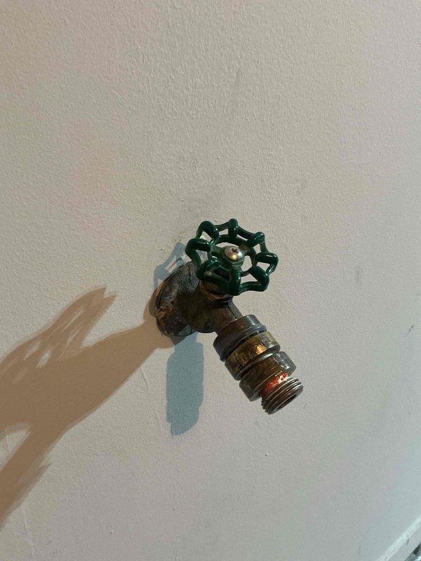 Responded to a leaking garage hose spigot with a failed vacuum breaker. Removed the heavily corroded exterior-mounted fixture and installed a new brass hose bib with integral vacuum breaker to prevent backflow contamination. The replacement resolved the leak and restored proper function to the garden hose connection point.