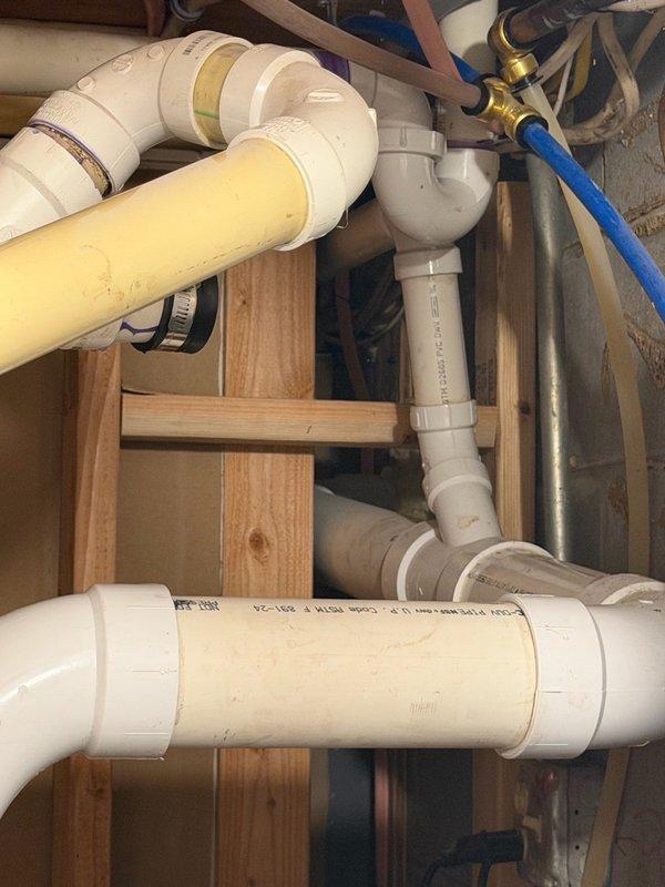 Responded to shower/tub drain issue with waste water odor concerns. Upon inspection, determined that installing a trap in the proposed location would not resolve the problem and would violate plumbing code requirements. Assessed the existing drain configuration and identified inadequate pipe sizing and lack of proper venting as root causes of the odor issue. Provided estimate for compliant repair solution including increasing pipe diameter, opening drywall section to install code-compliant trap beneath shower pan, and adding proper vent stack to eliminate sewer gas infiltration. Additionally identified non-compliant washing machine drain line installation and provided separate estimate for bringing system up to code standards.