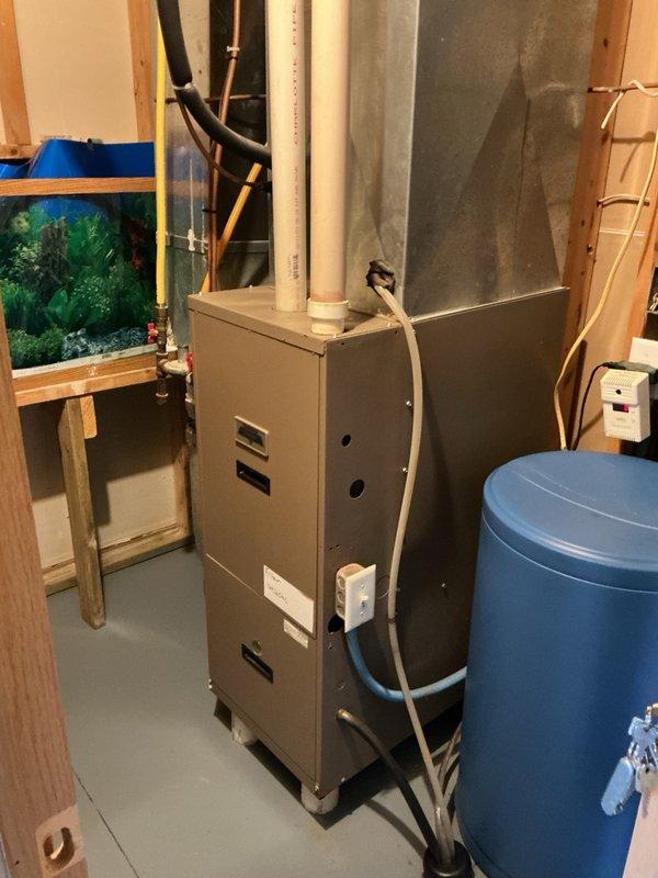 Performed comprehensive AC tune-up and inspection on 21-year-old R-22 system for homeowner preparing property for sale. Verified evaporator drain line was draining properly and replaced air filter with owner-supplied filter. Inspected outdoor unit electrical components including capacitor and contactor, both testing within acceptable parameters. System startup confirmed proper operation with 17-degree temperature split across evaporator coil. Unit cooling effectively with all components functioning as designed at time of service.
