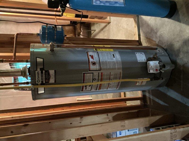 Responded to leaking temperature and pressure relief valve on a three-year-old water heater that was previously installed without an expansion tank. Upon arrival, found homeowner had rigged a temporary hose to direct water flow from the leaking T&P valve to the floor drain. Diagnosed the issue as thermal expansion causing excessive pressure in the closed plumbing system due to the absence of an expansion tank during original installation.

Installed a new expansion tank to accommodate thermal expansion and prevent future pressure buildup in the system. Replaced the failed temperature and pressure relief valve with a new unit. Properly connected the expansion tank to the cold water supply line using appropriate copper piping and fittings. Tested the system for proper operation and verified that all connections were secure with no leaks present.

Additionally, delivered and installed a UV bulb for the furnace as part of the service call. All work completed to code specifications, and the