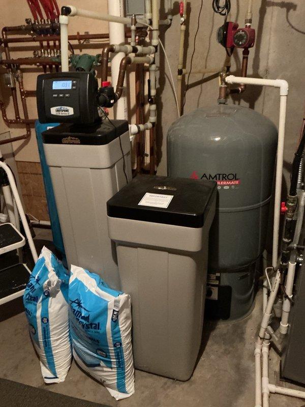 Completed comprehensive tune-up on both furnace and air conditioning system. Removed AC panels and thoroughly cleaned unit, removing debris despite recent homeowner rinsing. Inspected and verified all electrical components, checked metal reusable air filter, and flushed condensate drain lines on both systems. Cleaned furnace flame sensor, verified proper gas pressure settings and blower speed configurations. System testing confirmed furnace operating correctly with 50° temperature rise and air conditioner achieving 20° temperature drop, with all components functioning within normal parameters.