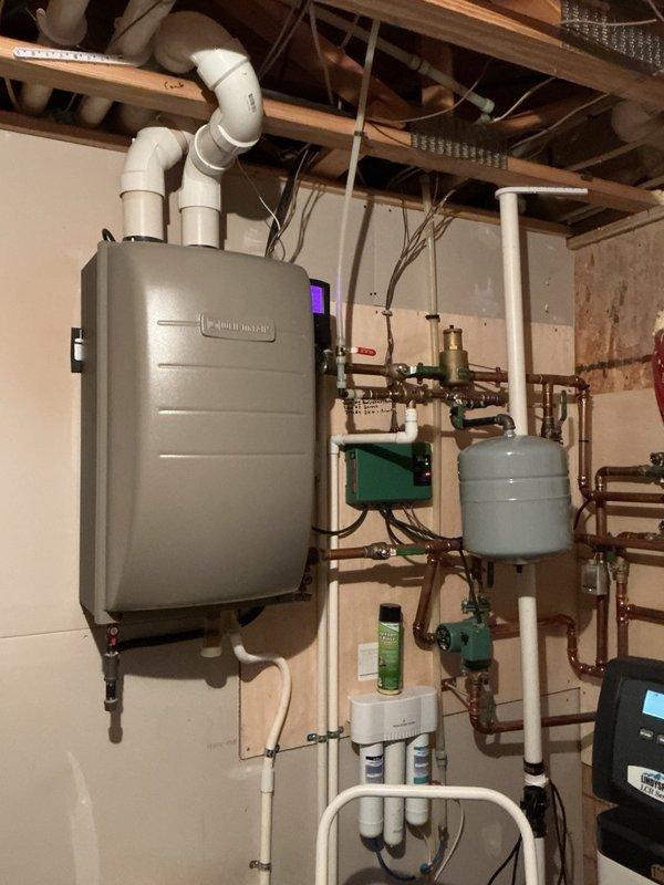 Completed comprehensive tune-up on both furnace and air conditioning system. Removed AC panels and thoroughly cleaned unit, removing debris despite recent homeowner rinsing. Inspected and verified all electrical components, checked metal reusable air filter, and flushed condensate drain lines on both systems. Cleaned furnace flame sensor, verified proper gas pressure settings and blower speed configurations. System testing confirmed furnace operating correctly with 50° temperature rise and air conditioner achieving 20° temperature drop, with all components functioning within normal parameters.