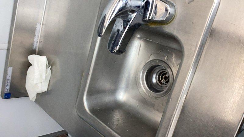 Responded to a standby call for a clogged hand wash sink at a commercial facility. Upon arrival, assessed the stainless steel sink and determined the drain line was obstructed. Successfully snaked the drain line to clear the blockage and restore proper drainage function.