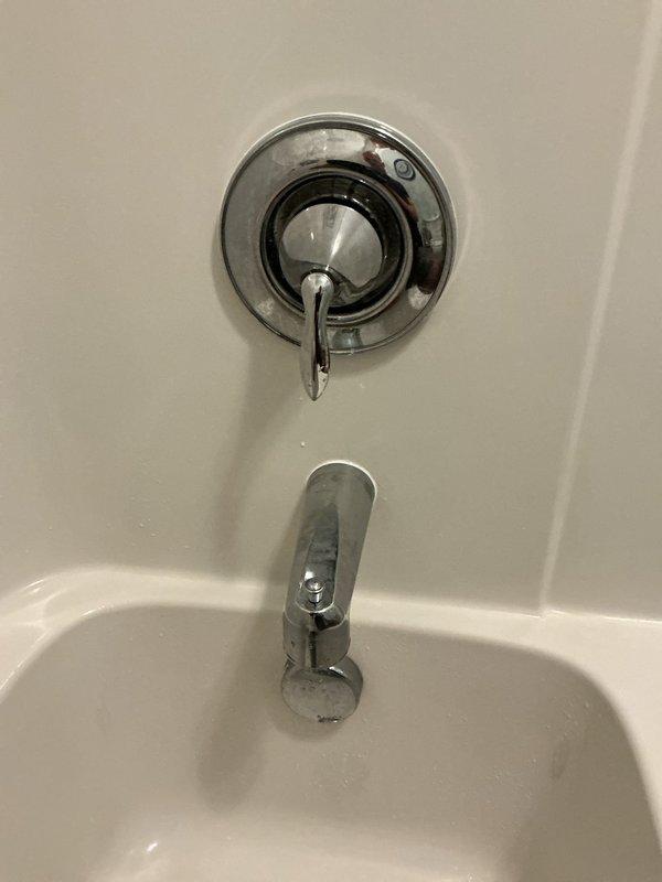 Responded to service call for malfunctioning bathroom shower valve where the cartridge had failed, preventing proper shut-off of water flow. Customer had been manually controlling the valve with a wrench prior to complete failure, which necessitated shutting off the main water supply to the residence. Disassembled the single-handle tub and shower control valve, removed the damaged cartridge with broken internal plastic components, and installed a new replacement cartridge. Tested the valve operation to ensure proper hot/cold water mixing and complete shut-off functionality. Restored water supply to the home and verified no leaks at the trim assembly.