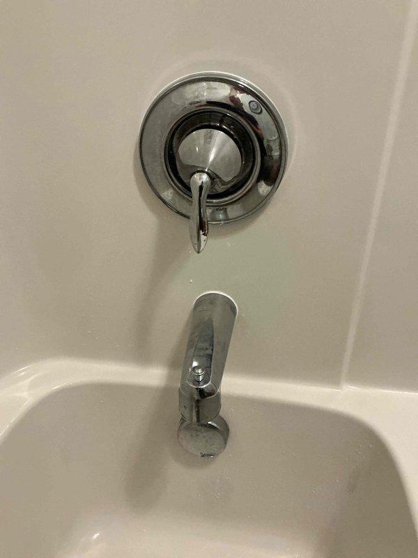 Responded to service call for malfunctioning bathroom shower valve where the cartridge had failed, preventing proper shut-off of water flow. Customer had been manually controlling the valve with a wrench prior to complete failure, which necessitated shutting off the main water supply to the residence. Disassembled the single-handle tub and shower control valve, removed the damaged cartridge with broken internal plastic components, and installed a new replacement cartridge. Tested the valve operation to ensure proper hot/cold water mixing and complete shut-off functionality. Restored water supply to the home and verified no leaks at the trim assembly.