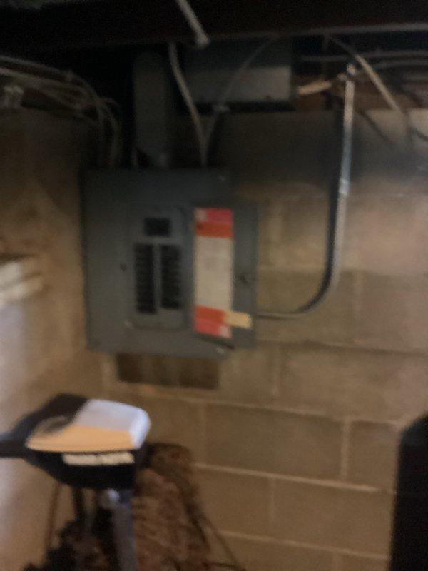 Responded to no hot water call with reported electrical issues including tripped breaker and sparking. Upon inspection, diagnosed failed heating elements and thermostats in existing 50-gallon electric water heater. Provided estimate for complete water heater replacement due to electrical failure and safety concerns. Documented existing installation showing water heater located in basement utility area with water treatment systems, along with electrical panel configuration. Recommended replacement over repair given the severity of electrical issues and potential safety hazards.