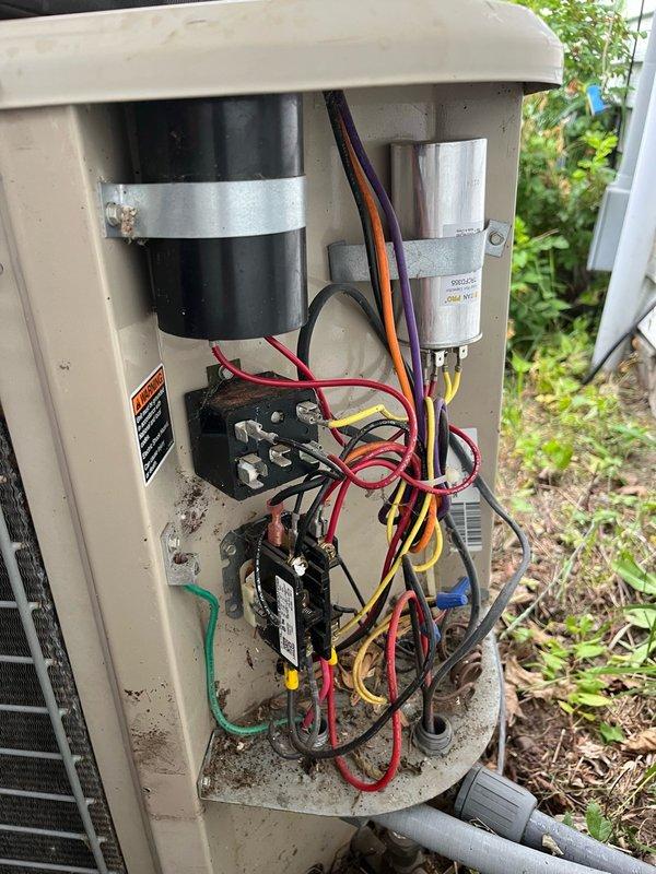 Responded to routine AC tune-up maintenance call on 24-year-old Lennox system. Upon arrival, found indoor blower operational but outdoor condensing unit not engaging. Inspection revealed severely pitted contactor with insect debris causing failure, and condenser fan motor showing signs of increased resistance. All other electrical components tested within acceptable parameters. Verified evaporator coil, blower assembly, and condensate drain line all clean and functioning properly; air filter in good condition.

Cleared debris from contactor to restore temporary operation of outdoor unit. Conducted 15-minute system performance test, confirming 15-16°F temperature split across evaporator coil. Measured operating pressures and identified low refrigerant charge on R22 system, indicating potential leak. All ductwork and indoor components found in satisfactory condition.

Given age of equipment, deteriorating contactor condition, stiffening fan motor, and low refrigerant levels, advised that