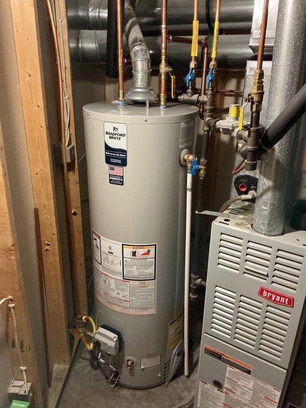 Responded to service call for 40-gallon natural gas tanked water heater experiencing active leak from bottom of unit. Upon arrival, confirmed 9-year-old Richmond brand water heater had ruptured tank with water actively leaking from base. Determined unit was beyond repair and required complete replacement. Removed and disposed of failed water heater, then installed new Bradford White 40-gallon natural gas water heater with proper venting and code-compliant connections. Connected copper supply lines with brass fittings and shutoff valves, installed gas line with appropriate yellow-tagged safety valve, and verified all plumbing connections for leaks. Tested unit operation, confirmed proper ignition and heating function, and ensured all safety features were operational before completing installation.