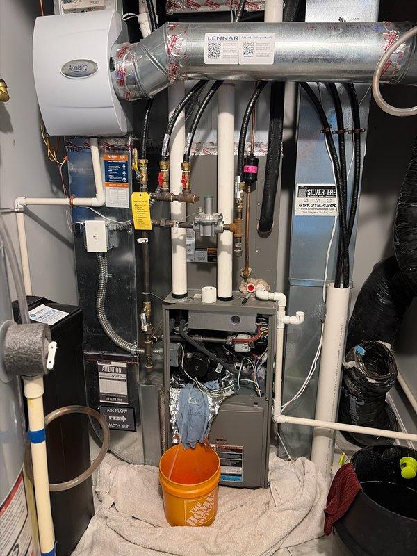 Responded to service call for evaporator pan leaking under cooling coils causing floor flooding on 2-year-old HVAC system. Cleared condensate drain line of accumulated debris and sludge buildup, then verified proper drainage flow and function. Recommended inducer motor gasket replacement before heating season to prevent future issues.