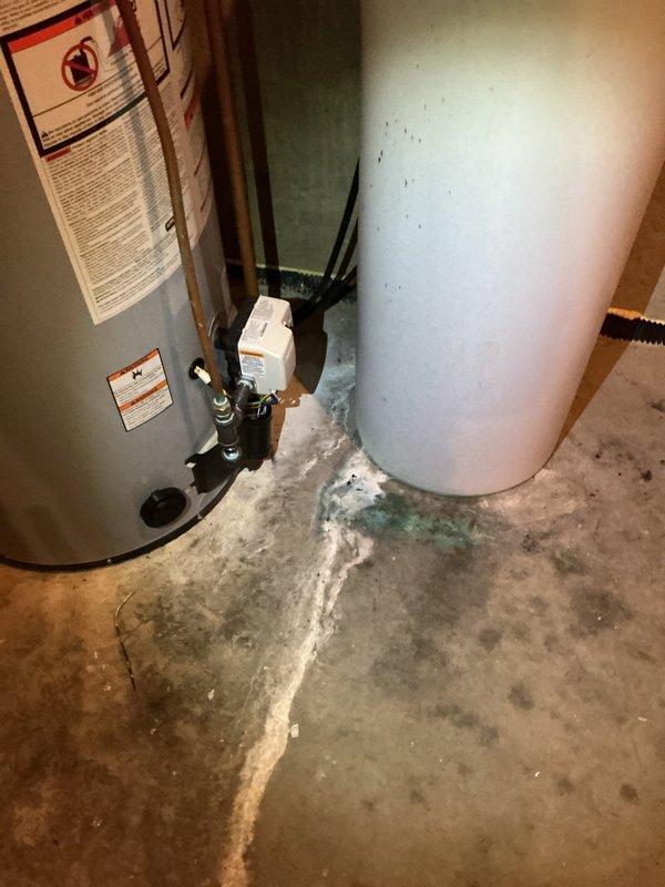 Performed comprehensive plumbing inspection at vacant residential property in preparation for sale. Identified and diagnosed multiple issues including leaking faucet handles at base on two upper-level bathroom fixtures and one additional bathroom faucet, all requiring replacement. Repaired refrigerator water supply line connection where copper pipe meets plastic fitting, eliminating active leak and restoring water supply to appliance. Evaluated existing water softener system and determined unit was not functioning correctly due to age and wear. Provided detailed estimate for faucet replacements and water line repair, which was approved by property owner. Documented all findings with photographic evidence of basement utility area showing water treatment equipment and water heater installations with visible floor staining indicating prior moisture issues. Coordinated follow-up service appointment for approved repair work. Confirmed completion of full inspection checklist with property ow