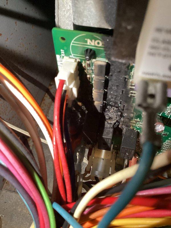 Responded to no cooling complaint on 2021-installed HVAC system still under warranty. Upon inspection, discovered the main control board had failed catastrophically with visible heat damage and charring to the circuit board assembly. Removed damaged control board and installed replacement unit, restoring system to full operational status.