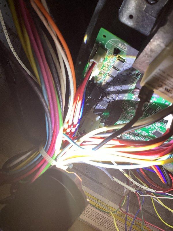 Responded to no cooling complaint on 2021-installed HVAC system still under warranty. Upon inspection, discovered the main control board had failed catastrophically with visible heat damage and charring to the circuit board assembly. Removed damaged control board and installed replacement unit, restoring system to full operational status.