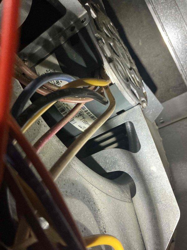 Responded to a no cooling call on a 24-year-old American Standard air conditioning system. Upon arrival, attempted to diagnose the AC unit but discovered the indoor furnace blower motor was completely seized and inoperative. Without airflow from the blower motor, unable to properly test or evaluate the air conditioning system's cooling performance or refrigerant circuit operation.

Conducted visual inspection of the furnace heat exchanger and identified significant corrosion present on the heat exchanger tubes at their connection points to the front panel of the furnace. The corrosion pattern indicates potential separation of the tubes, which presents a safety concern for future heating operation. Documented findings with photographs of both the outdoor condensing unit and the seized indoor blower motor assembly.

Explained to the customer that the seized blower motor must be addressed before any AC diagnostics can be completed, as the system requires proper airflow to safely operate a