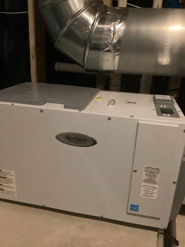 Responded to service call for whole-home dehumidifier not achieving setpoint of 40-45% relative humidity, with readings remaining at 60%. Upon inspection of the Aprilaire dehumidifier and connected HVAC system, identified that the air exchanger was introducing outdoor humid air into the system, preventing the dehumidifier from reaching target humidity levels. Deactivated the air exchanger to resolve the immediate humidity control issue, after which the system successfully reduced indoor humidity to desired levels. Advised that the air exchanger will need to be reactivated and properly configured for operation during winter months to provide adequate fresh air ventilation. Enrolled customer in rewards program for ongoing service benefits.