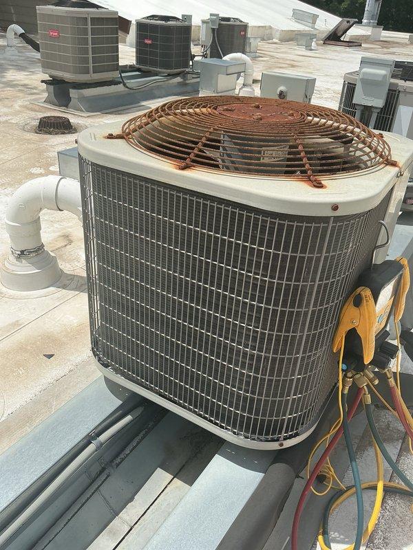 Performed annual AC tune-up on 10-year-old rooftop condenser unit with ceiling-mounted fan coil. Cleaned condenser coils of cottonwood debris and tested system refrigerant levels, which measured lower than previous year's readings despite recharge performed last season, confirming suspected refrigerant leak. Scheduled follow-up appointment for new system replacement estimate.