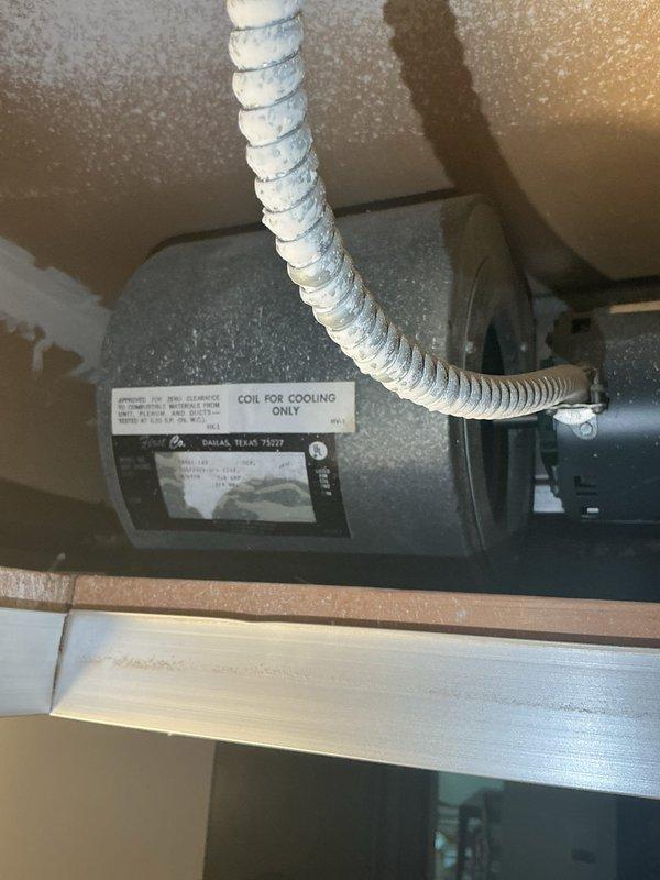 Performed annual AC tune-up on 10-year-old rooftop condenser unit with ceiling-mounted fan coil. Cleaned condenser coils of cottonwood debris and tested system refrigerant levels, which measured lower than previous year's readings despite recharge performed last season, confirming suspected refrigerant leak. Scheduled follow-up appointment for new system replacement estimate.