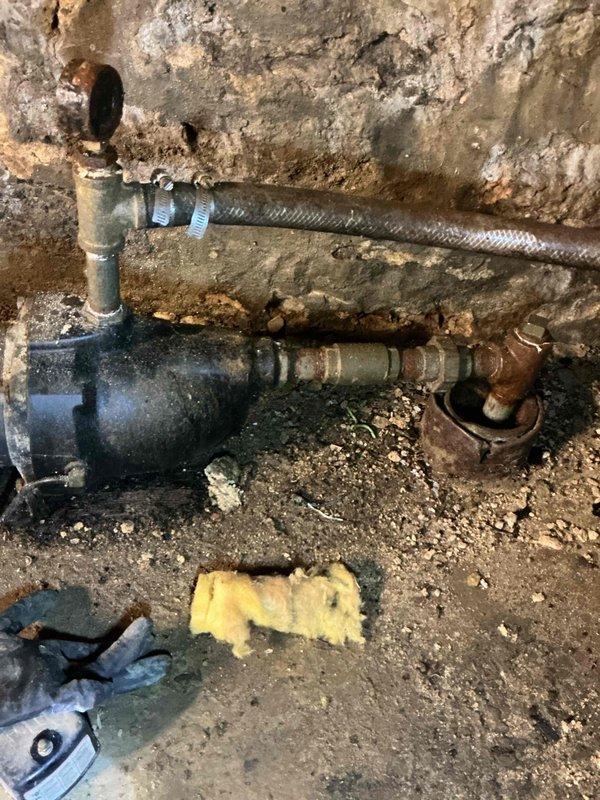 Responded to initial call for low water pressure affecting shower and outside faucet. Upon arrival, situation had escalated to complete water loss. Investigation revealed circuit breaker for shallow well pump was in off position. Attempted to restore power, but breaker immediately tripped with visible arcing inside electrical panel, indicating electrical failure. Diagnosed shallow well pump as failed due to internal short circuit causing the electrical fault. System rendered inoperable and unsafe for continued use. Documented existing conditions including corroded plumbing components and deteriorated pump assembly in basement utility area. Initiated parts order form for pump replacement to restore water service to property.