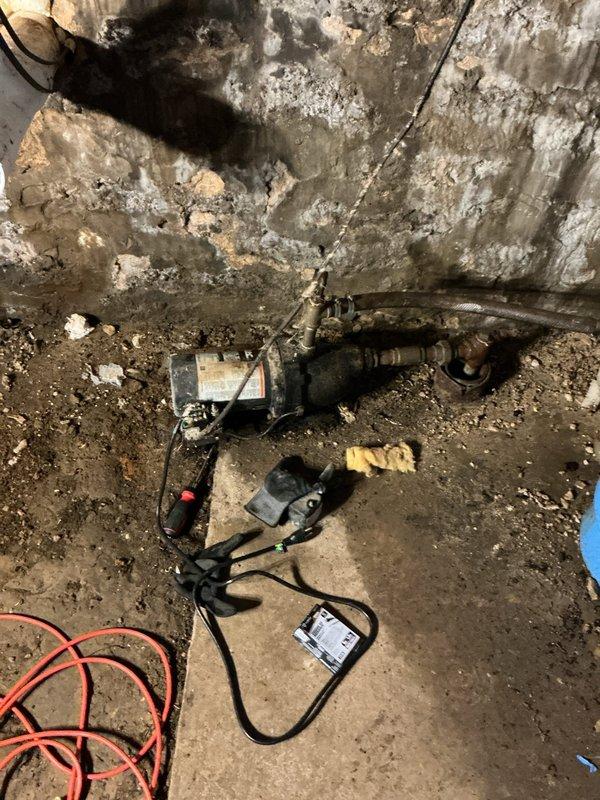 Responded to initial call for low water pressure affecting shower and outside faucet. Upon arrival, situation had escalated to complete water loss. Investigation revealed circuit breaker for shallow well pump was in off position. Attempted to restore power, but breaker immediately tripped with visible arcing inside electrical panel, indicating electrical failure. Diagnosed shallow well pump as failed due to internal short circuit causing the electrical fault. System rendered inoperable and unsafe for continued use. Documented existing conditions including corroded plumbing components and deteriorated pump assembly in basement utility area. Initiated parts order form for pump replacement to restore water service to property.