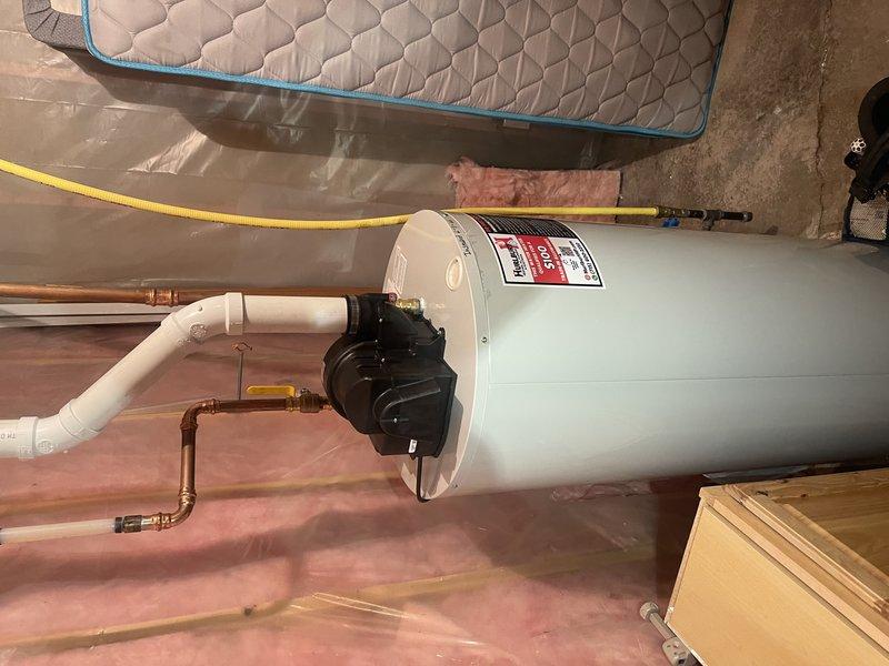 Responded to gas leak complaint at water heater location where odor was detected outside when unit operated. Upon investigation, determined that incorrect fuel type water heater had been installed - natural gas unit was present where propane unit was required. Coordinated with team to obtain correct propane water heater for replacement. Drained existing natural gas water heater and disconnected all plumbing connections in preparation for removal. Assisted with removal of incorrect unit and installation of proper propane water heater to resolve gas leak issue and ensure safe operation.